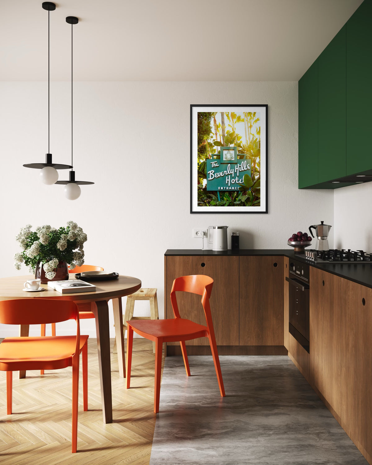 Green-cabinet kitchen with orange chairs and framed Beverly Hills Hotel Sign in Los Angeles on the wall.