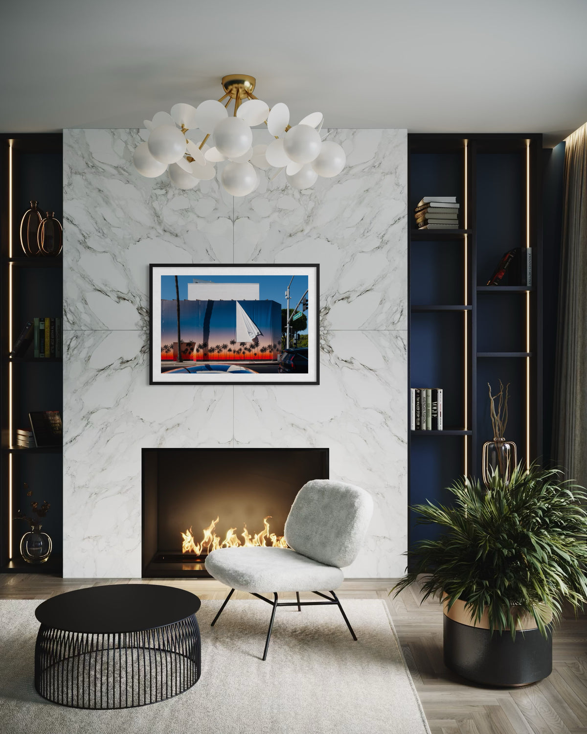 Marble fireplace and abstract chandelier in a living room with Beverly Hills Revealed sunset artwork on the wall.