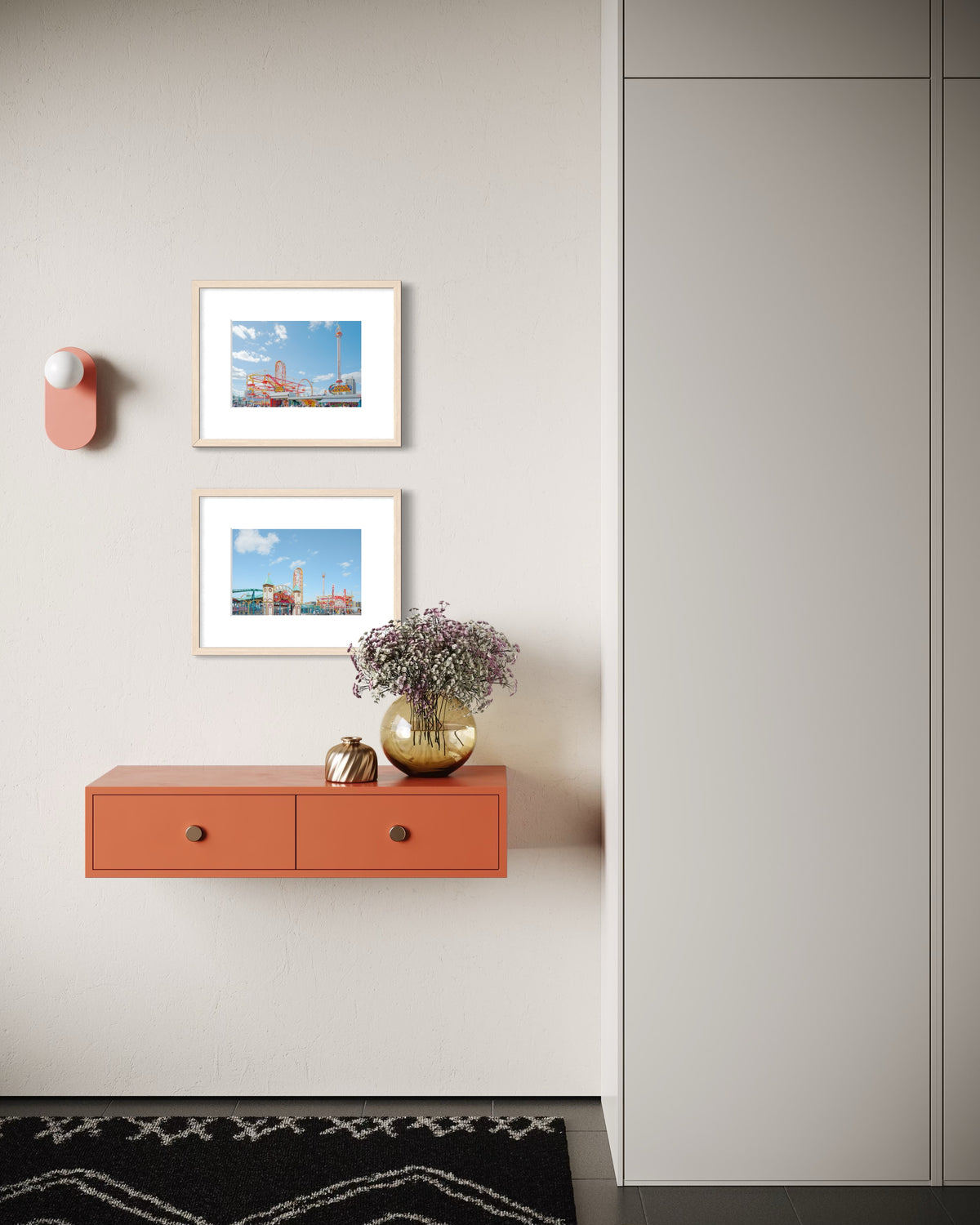 Modern hallway with orange shelf, gold vase, and Coney Island Pairing photograph on a light-colored wall.