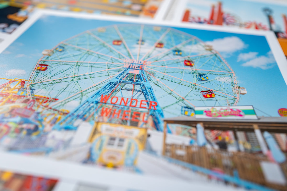Brightly colored Wonder Wheel at Coney Island, New York, viewed against a blue sky.