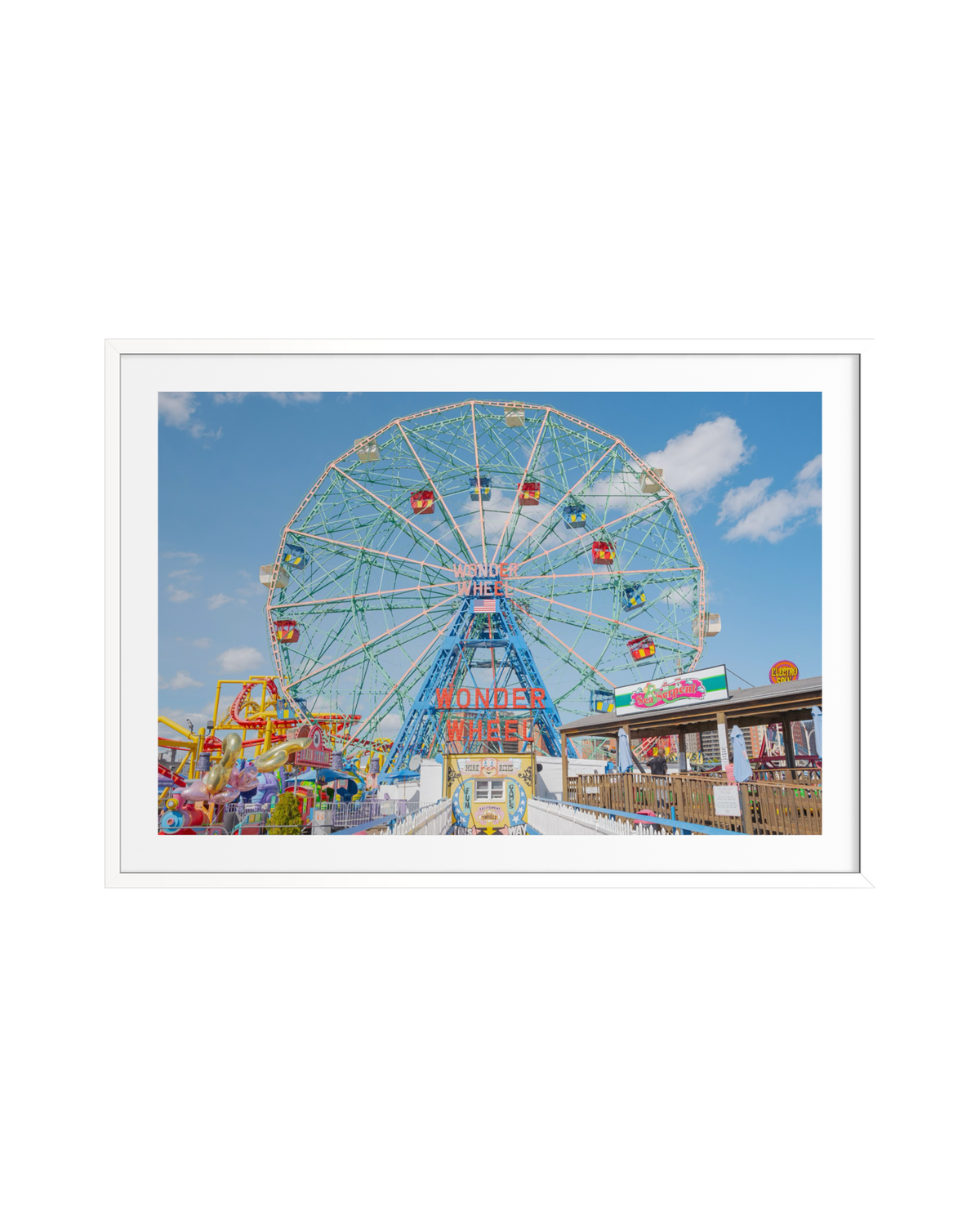 Coney Island Wonder Wheel beneath a blue sky with scattered clouds in Brooklyn, New York.