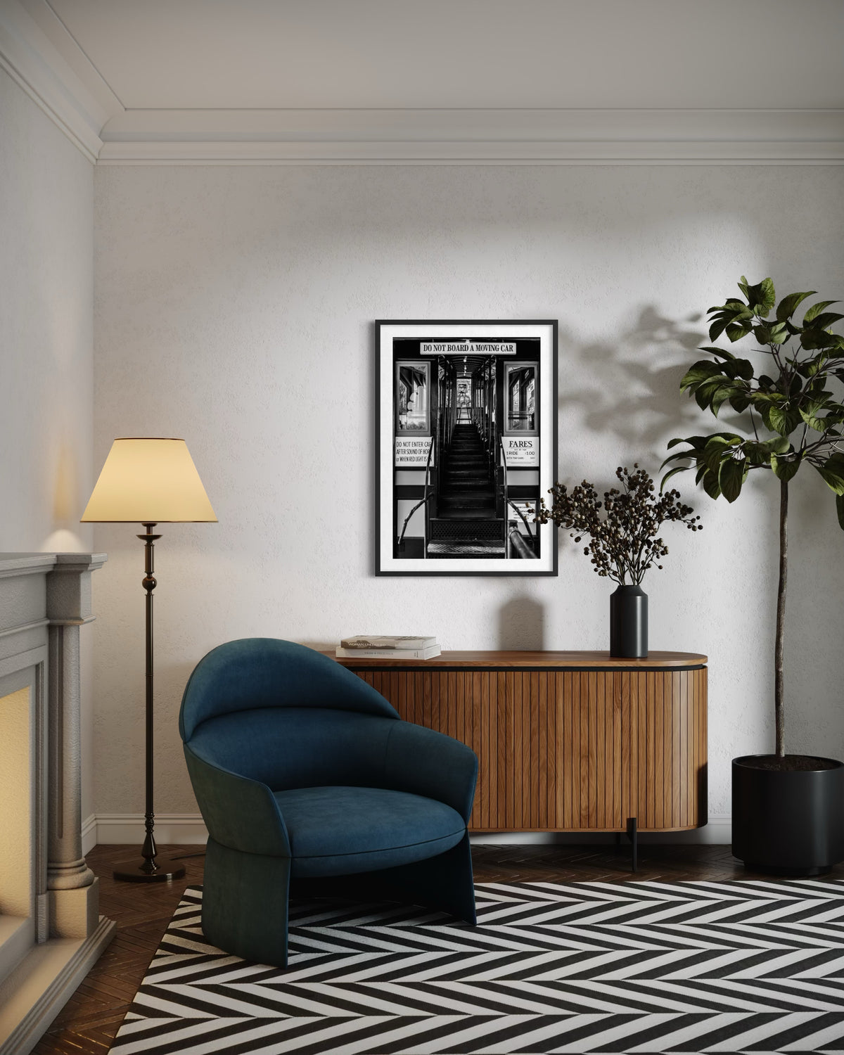 Black-and-white photo of the DTLA Funicular Passage on a wall above a blue chair and plant in a living room.