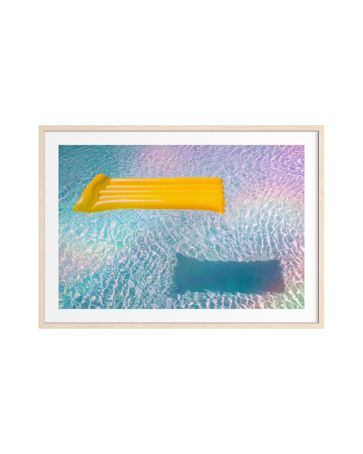 Yellow pool float drifting on blue water, from the Refractions Collection photography print.