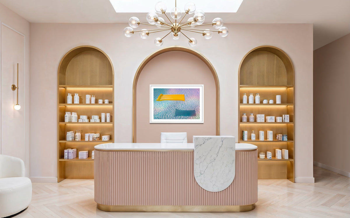 Marble reception desk, pastel walls, and arched shelves with products at a modern spa.