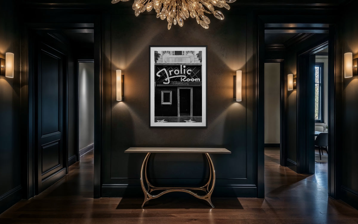Art Deco hallway in Los Angeles with console table, wall lights, and Frolic Room photo under a modern chandelier.