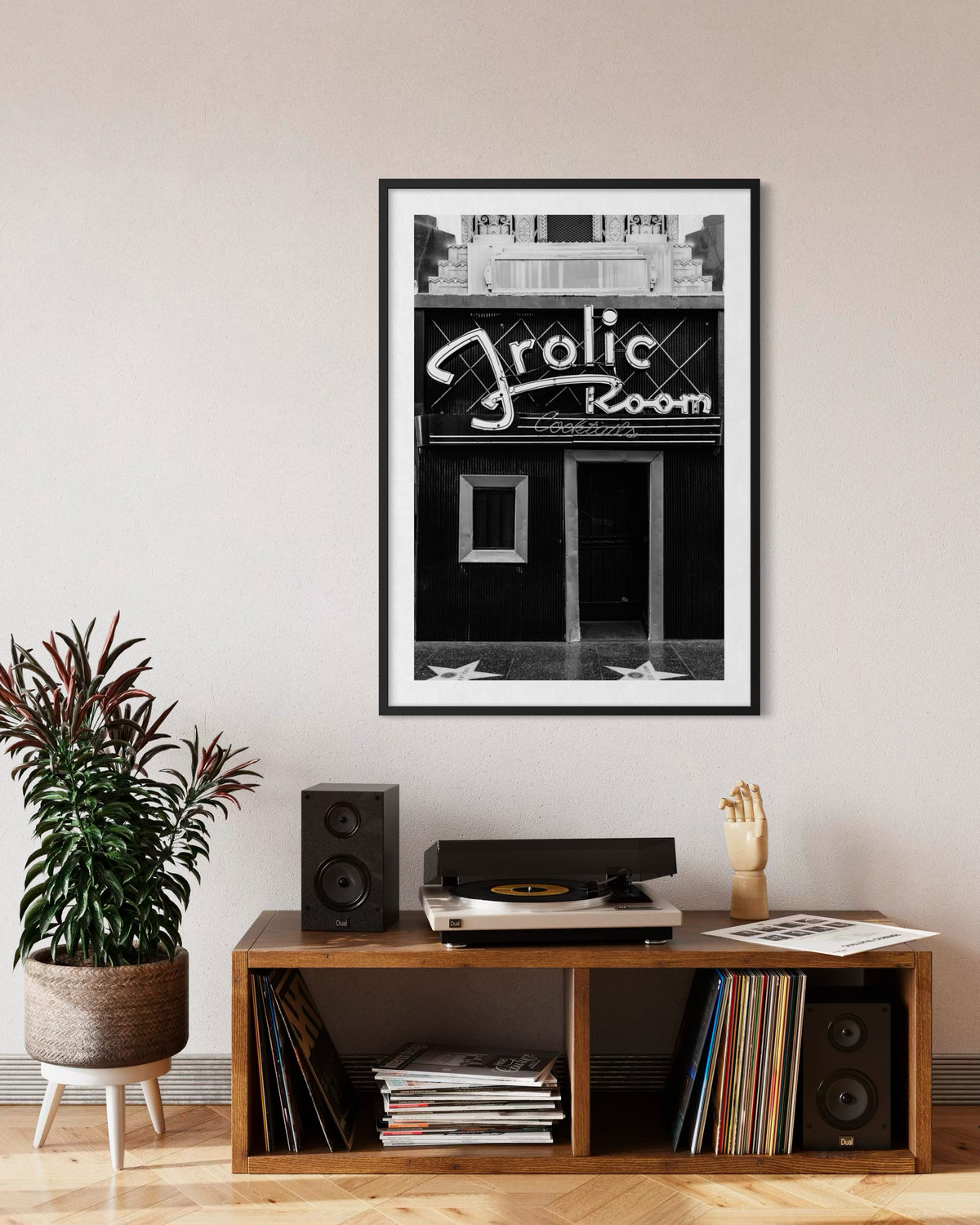 Frolic Room Art Deco sign in Los Angeles, photographed above a record player, speakers, and potted plant.