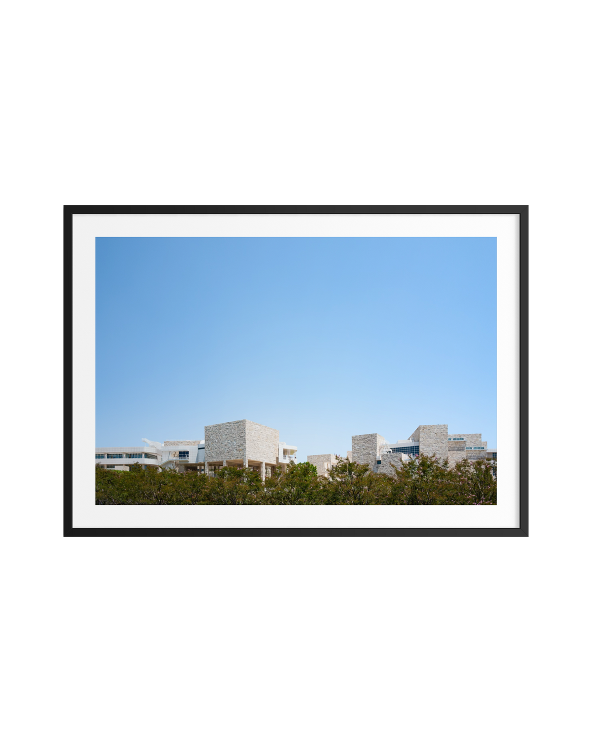 Modern architecture at the Getty Center in Los Angeles, travertine walls, blue sky, and greenery.