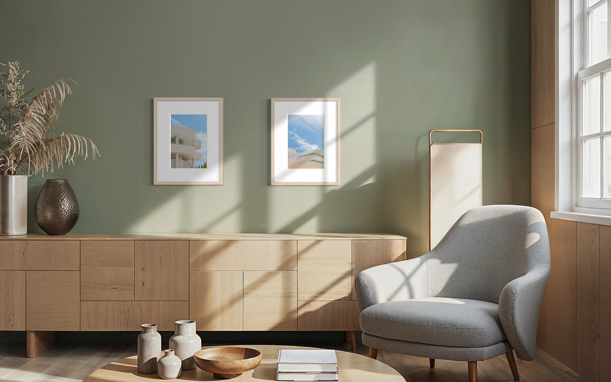 Light wood furniture and gray chair in a sunlit living room, Getty Center Pairing art on the wall.