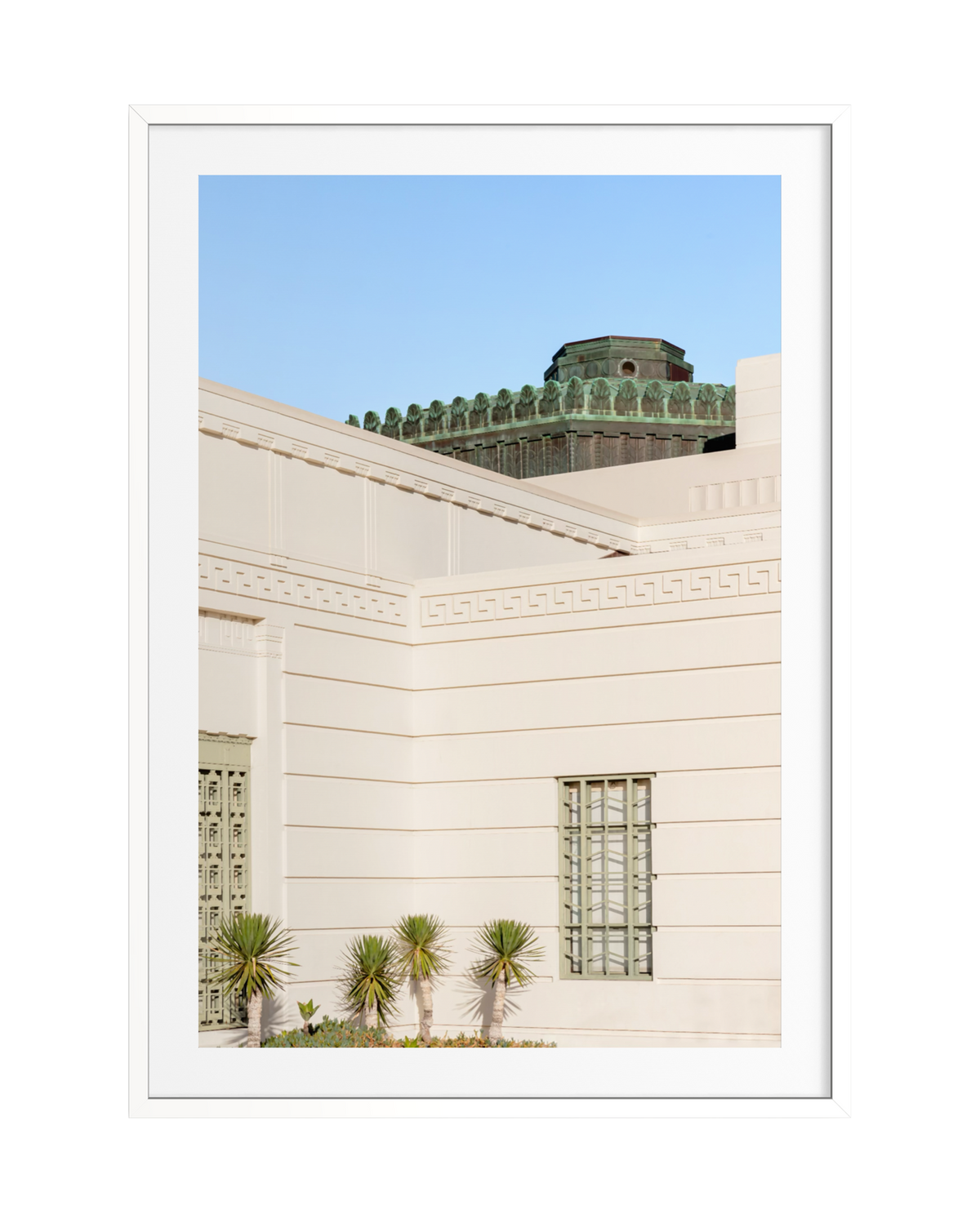 Griffith Observatory’s white Art Deco building and palms under a clear blue sky in Los Angeles, California.
