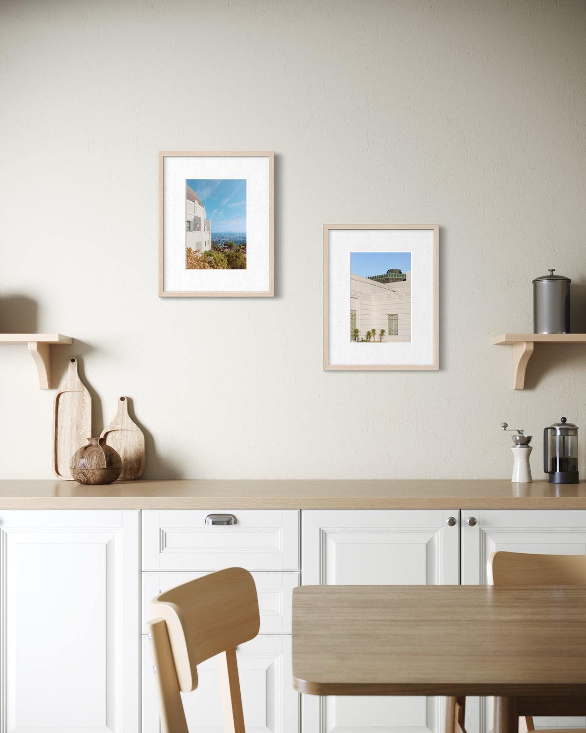 White cabinets and wood shelves in a kitchen, with framed Griffith Observatory art on the wall.