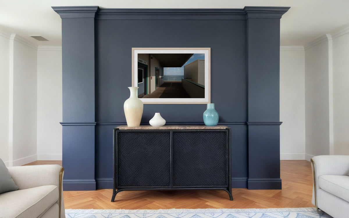 Three vases, framed art, and a navy accent wall in a Harbor Office with Pacific Ocean view.