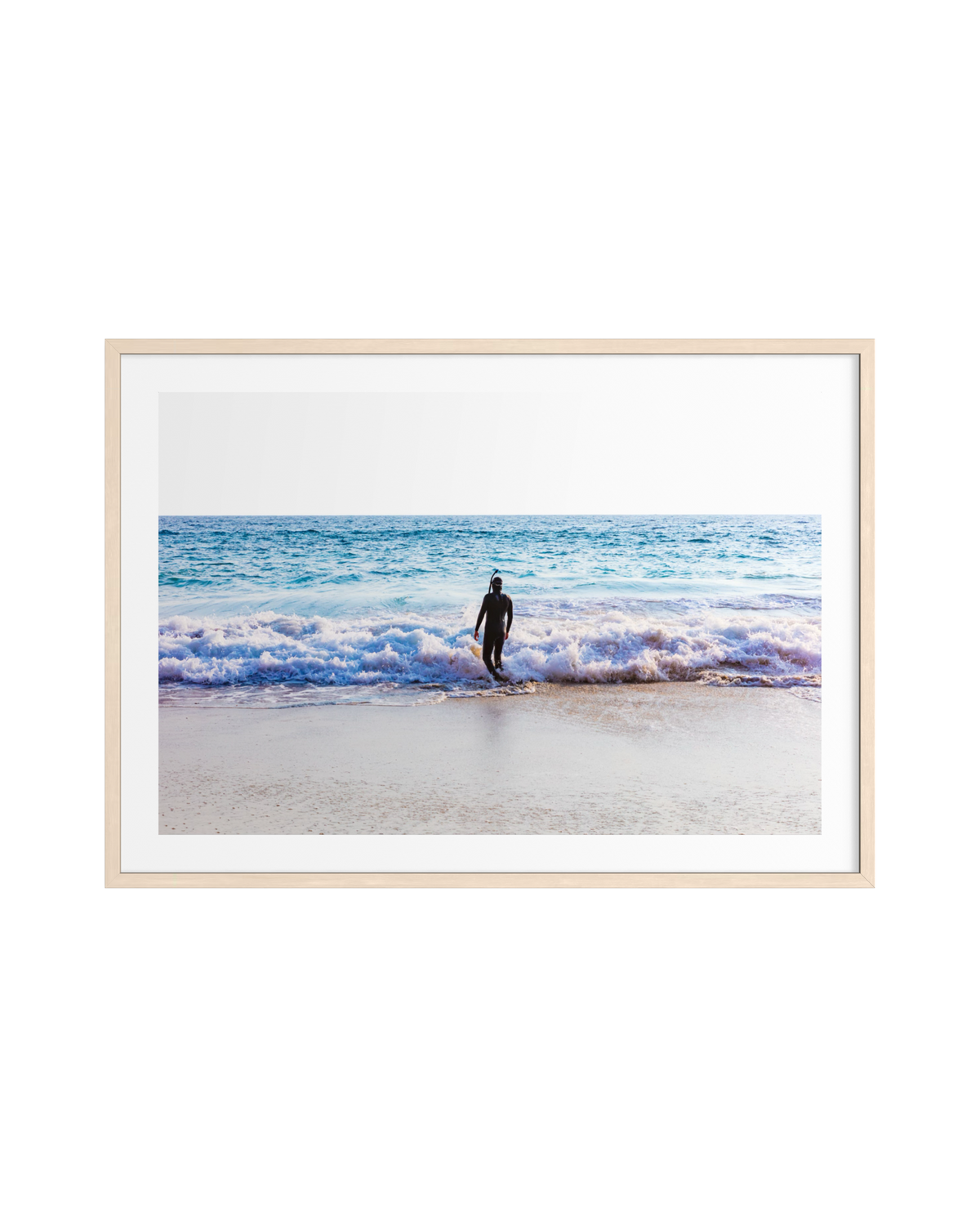 Person in a wetsuit stands alone on the Pacific shore as waves break, from “Into The Sea.”.