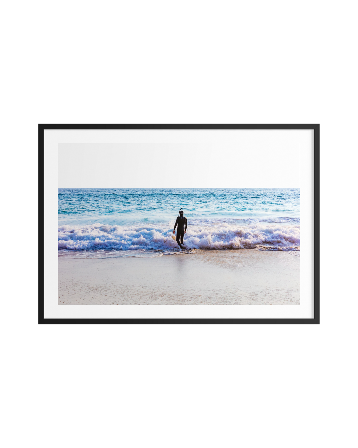 Person in wetsuit stands alone on the shore beneath a dreamy sky in “Into The Sea.”.