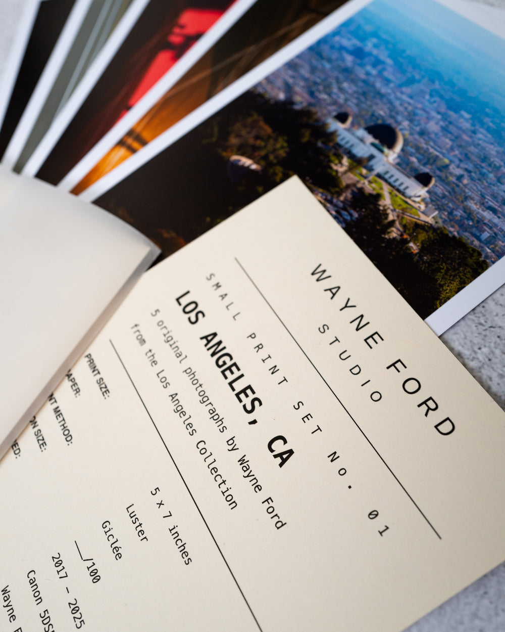 Color Los Angeles photo prints and a WAYNE FORD STUDIO card arranged on a tabletop.