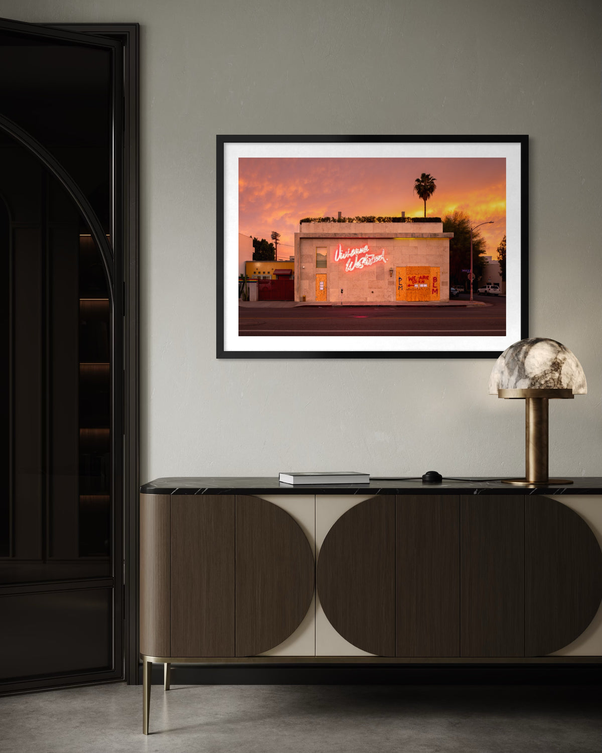 A photograph of Melrose Avenue, Los Angeles in summer 2020 displayed above a modern sideboard at sunset.