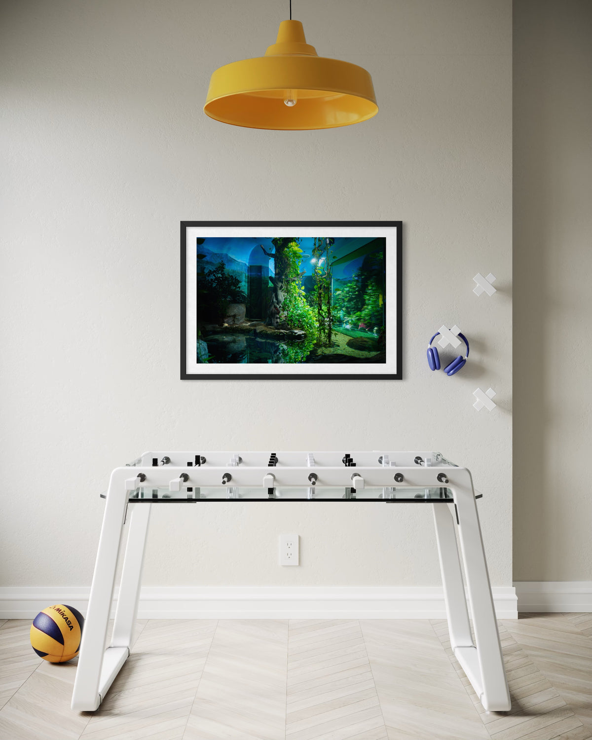 White foosball table beneath a yellow lamp with headphones above, photographed at night in Los Angeles.