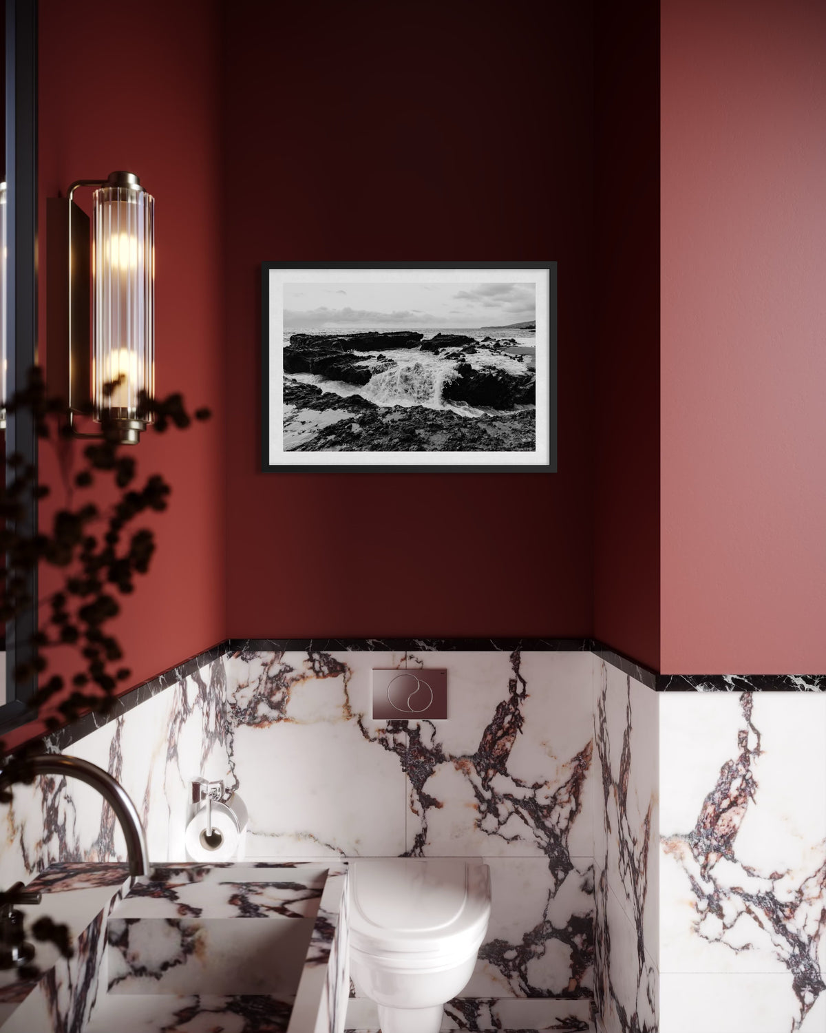 Modern bathroom with marbled walls, red accents, a toilet, and ‘Ocean Momentum’ artwork framed above the toilet.