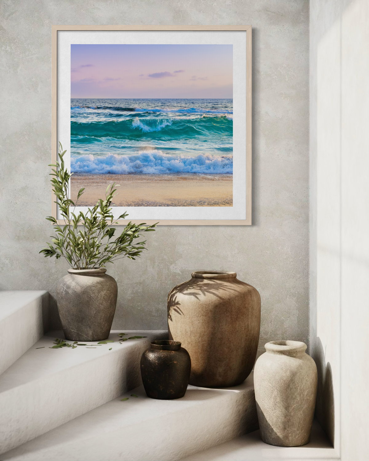 Ocean Waves II print hangs on a textured wall above vases with greenery, positioned on white stairs.