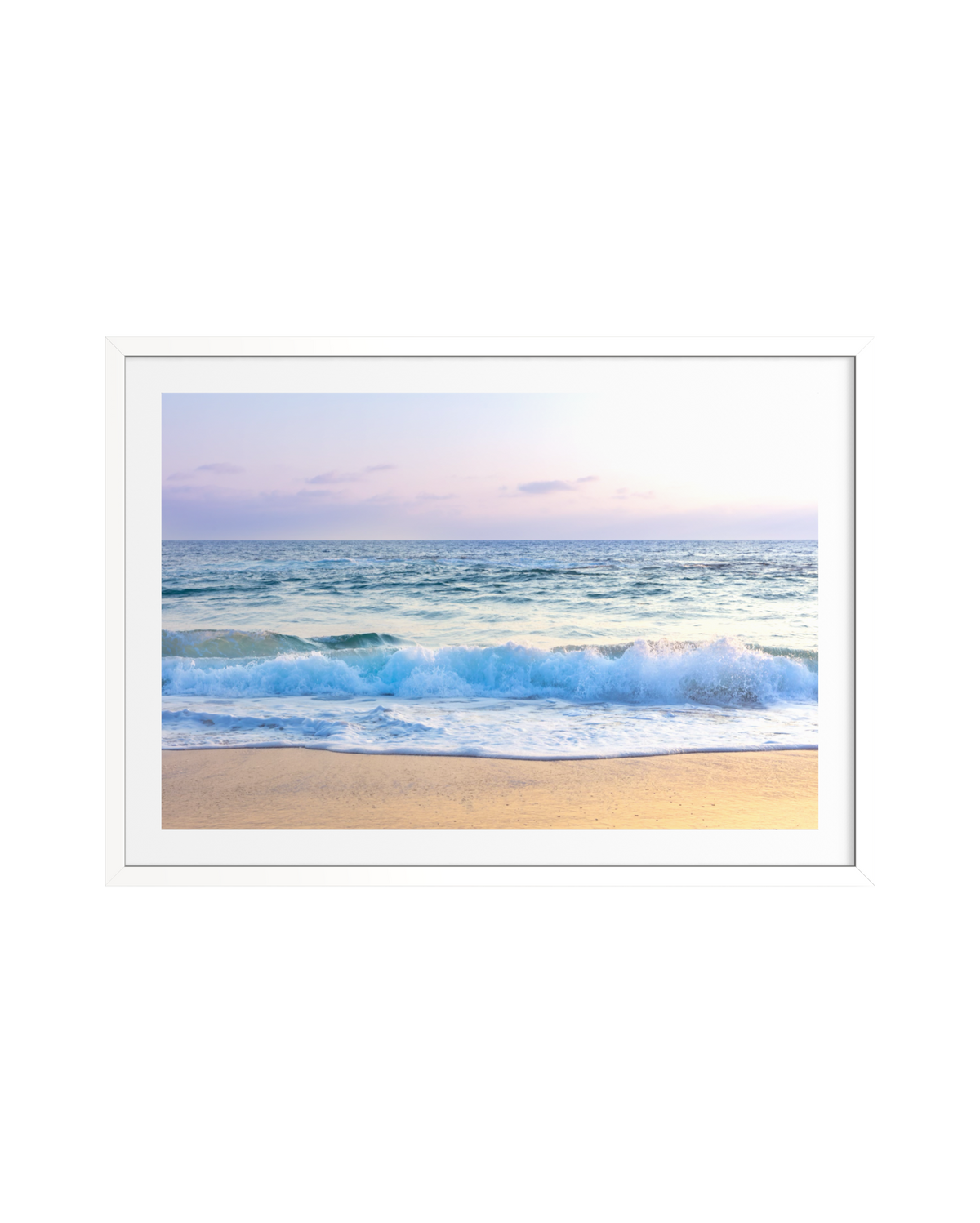 Pacific waves at Laguna Beach roll beneath a soft pastel sky, captured in a framed photograph.