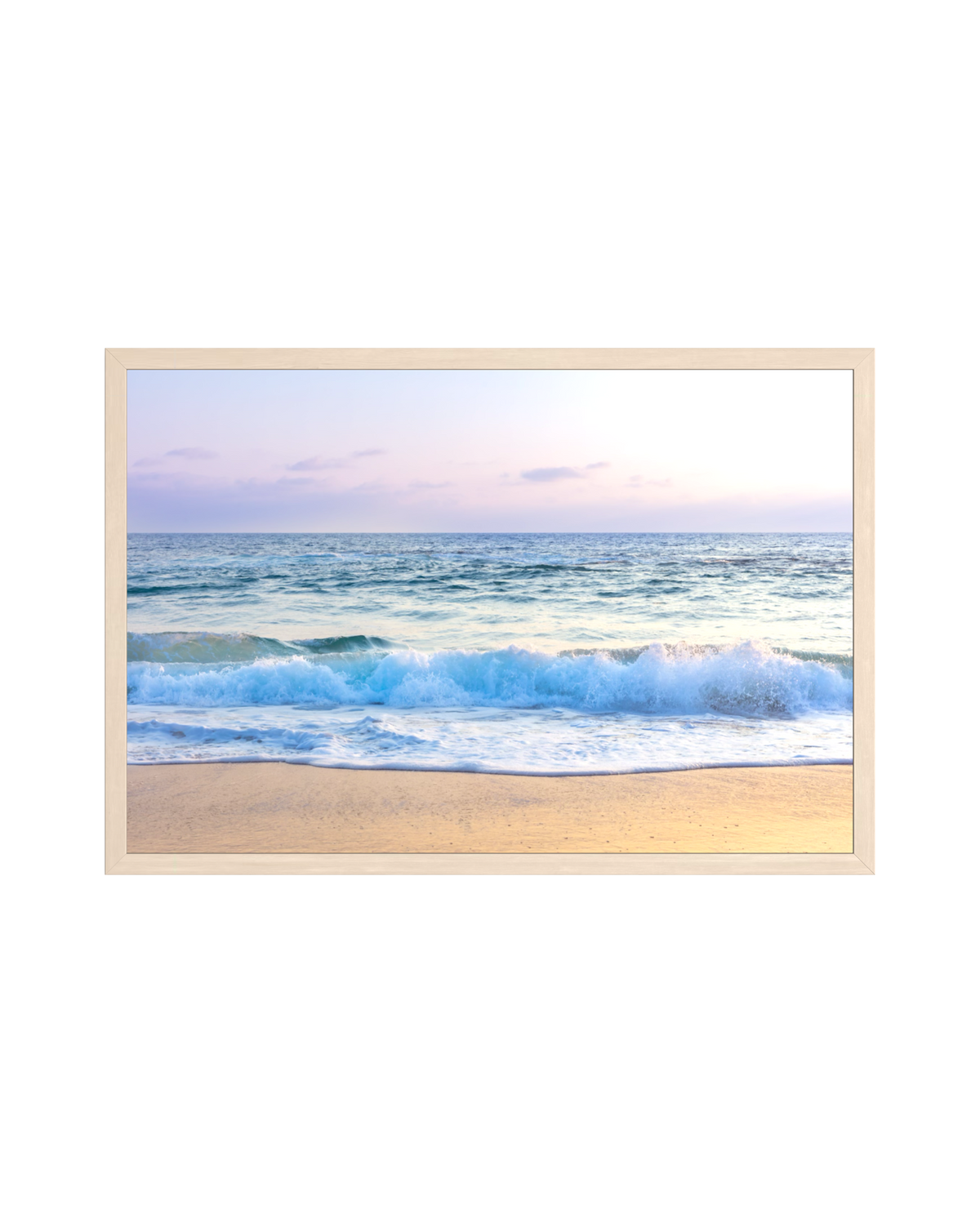 Pacific waves at sunrise on Laguna Beach under pastel skies, shown in a light wood frame.