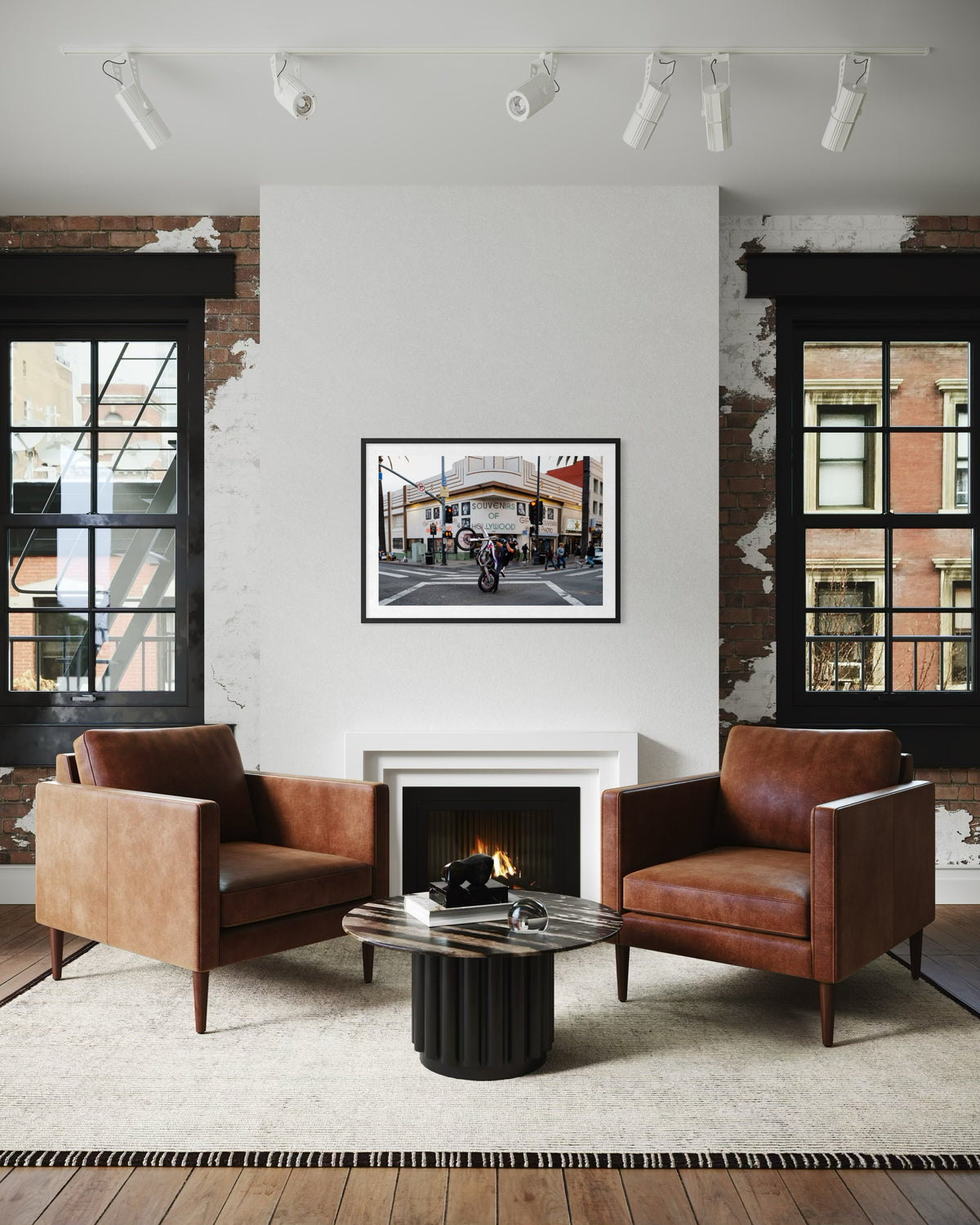 Two Hollywood chairs facing each other by a fireplace in a modern living room with celebrity photos, Los Angeles.