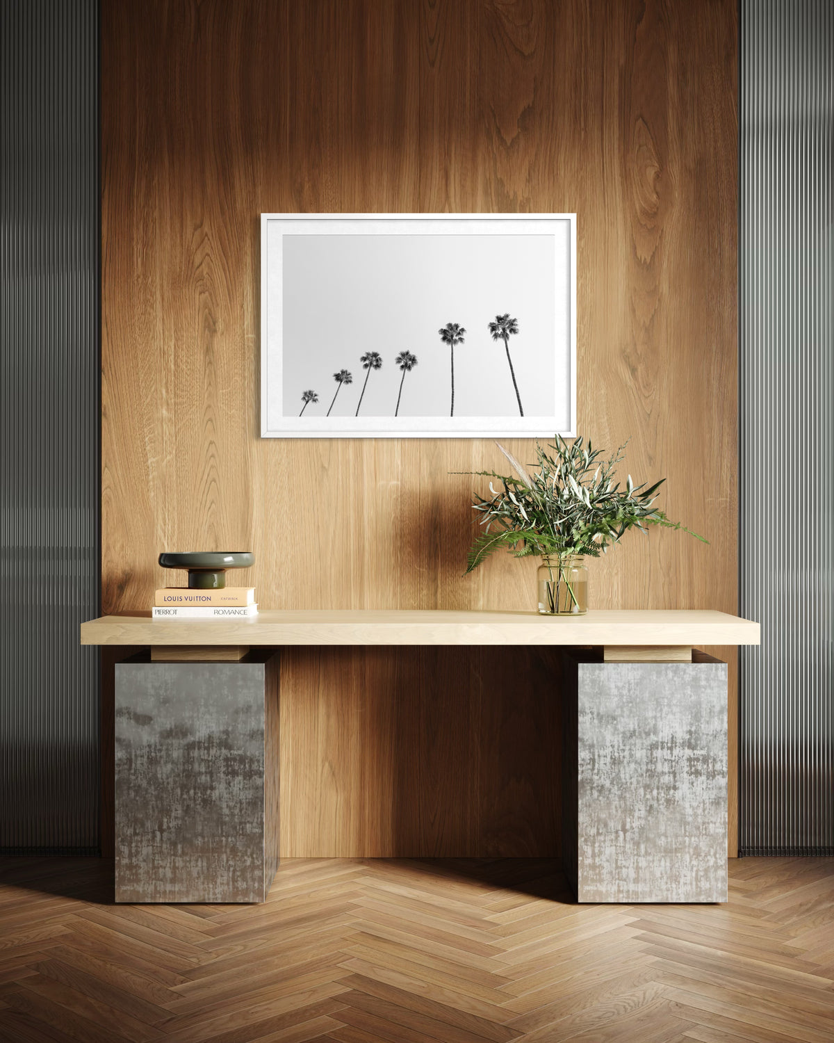 Console table with thick gray legs, books, and Palm Rhythm artwork against a wood-paneled wall.