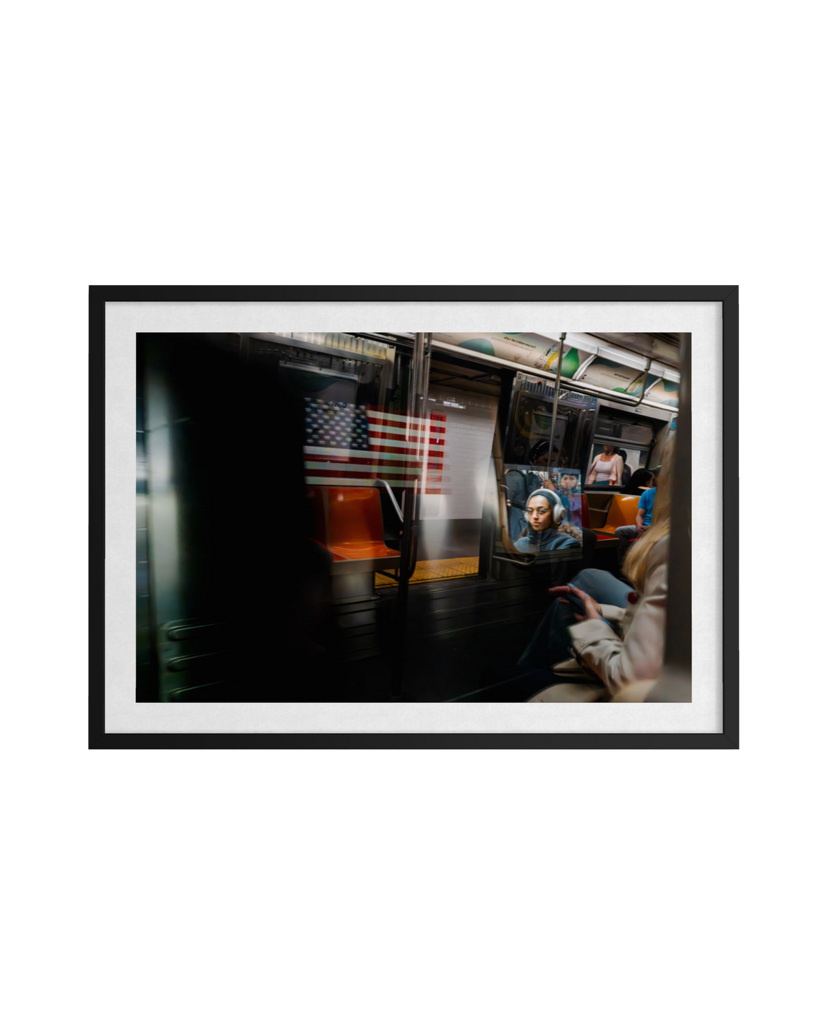 Passengers and an American flag reflected in a D train window, New York City. Another train passes by outside.