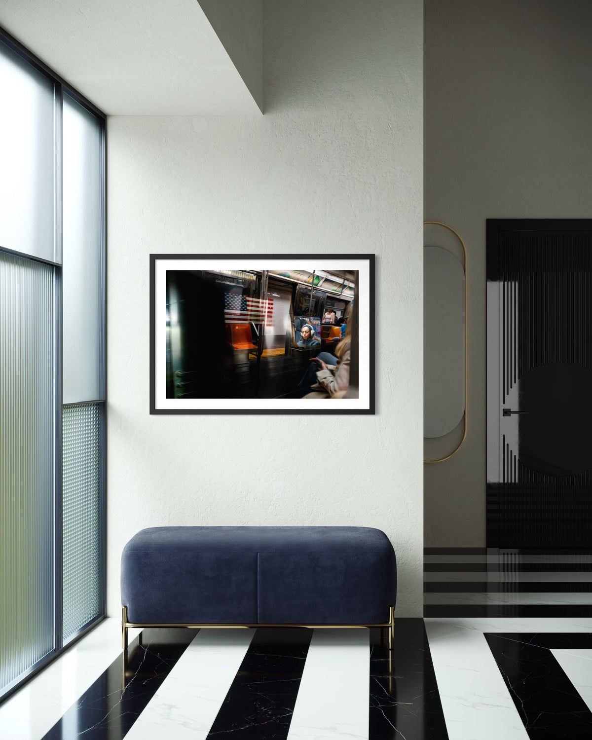 Black-and-white photo of a passing train in New York City, framed and displayed above a blue bench.