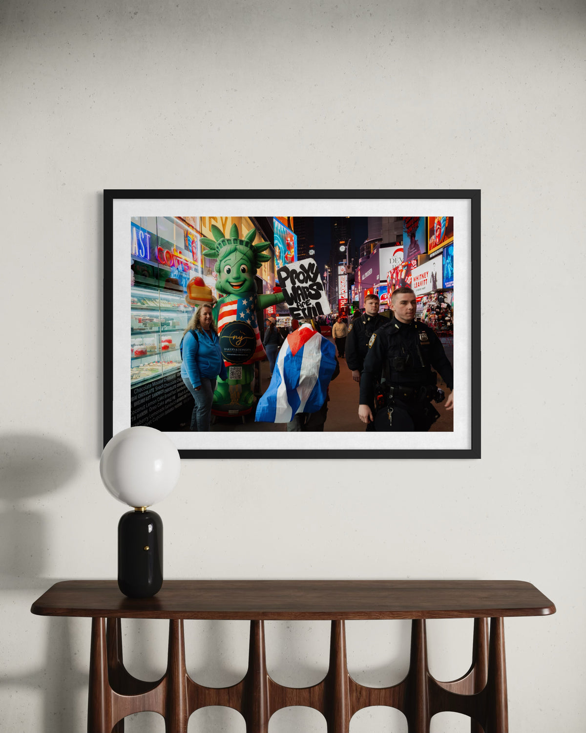 Times Square scene with a “Proxy Wars Are Evil” sign, shown in a framed photo above a shelf.