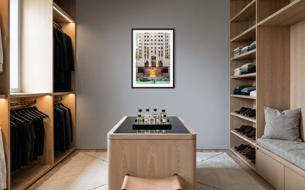 Walk-in closet with wooden shelves, neatly arranged clothes, and a Prometheus mural. New York City.