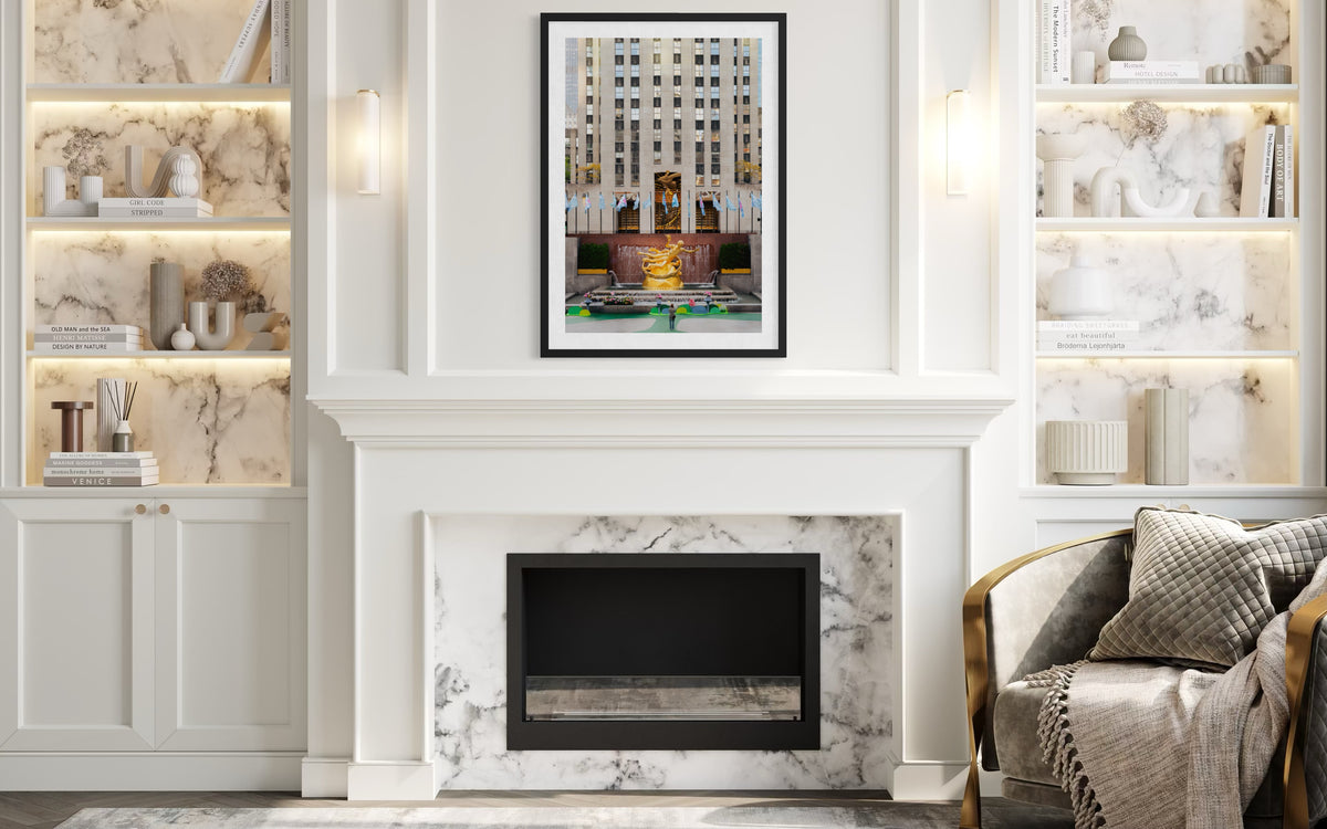 Living room with marble fireplace, built-ins, and Rockefeller Center’s Prometheus statue above the mantle.