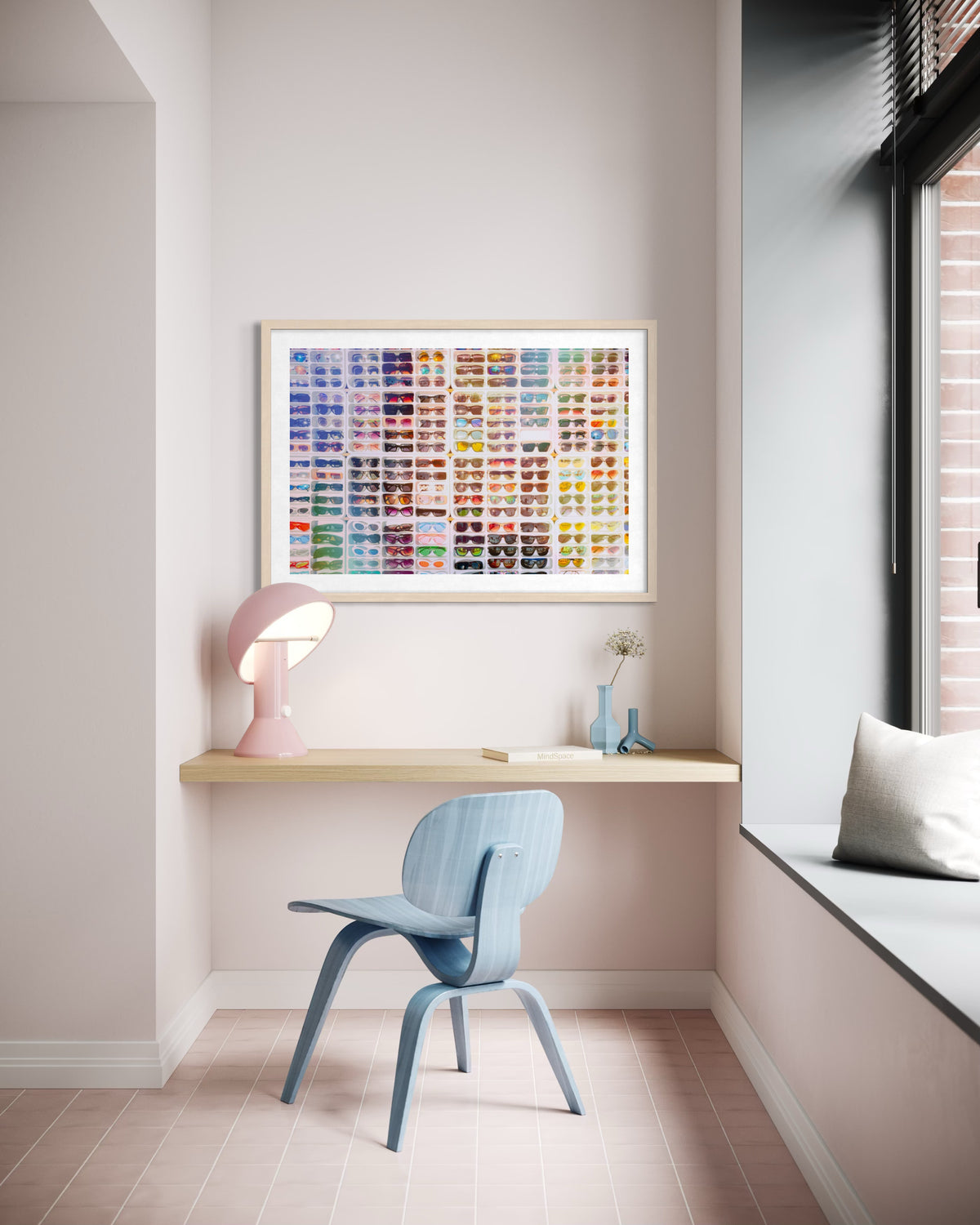 Pastel blue chair and wooden desk beneath “Shades of Summer” art in a simple, bright workspace setting.
