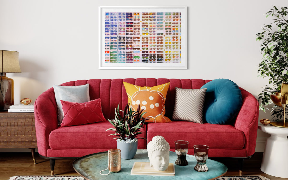Red sofa with colorful pillows under “Shades of Summer” print, beside plants and decor in a framed artwork mockup.