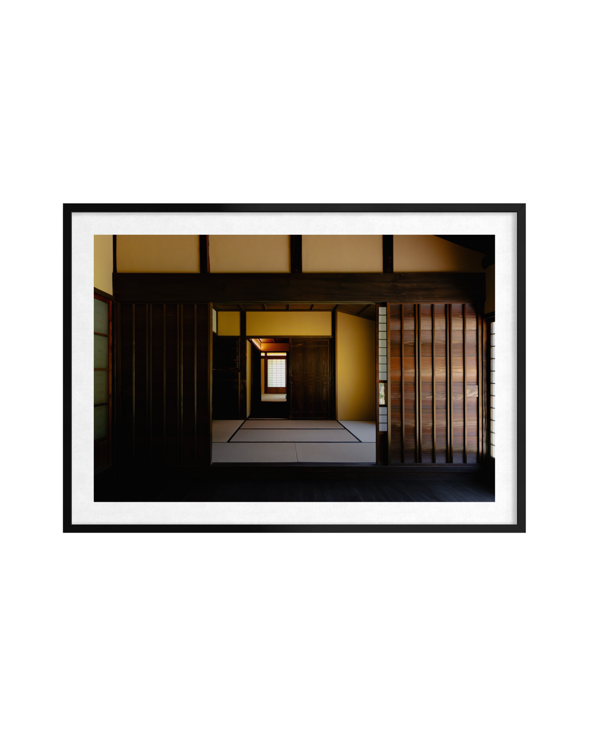 Minimalist Japanese room in Shōya House, with sliding doors, warm lighting, and rich wood accents.