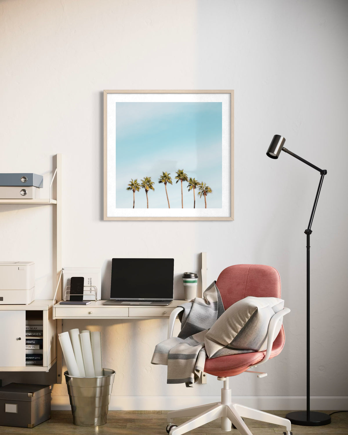 Desk with laptop, pink chair, lamp, and Six Palms artwork displayed in a modern home office setting.