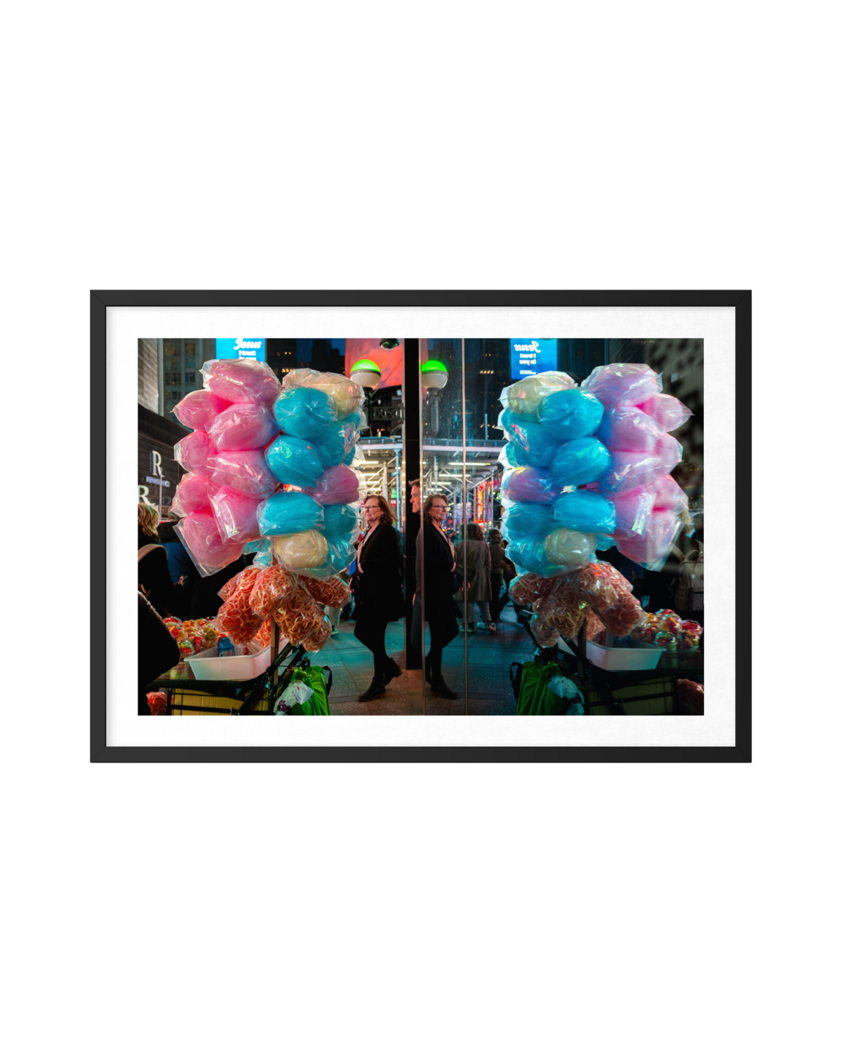 Cotton candy bouquets and mirrored people on a Times Square street, framed by bright city lights.