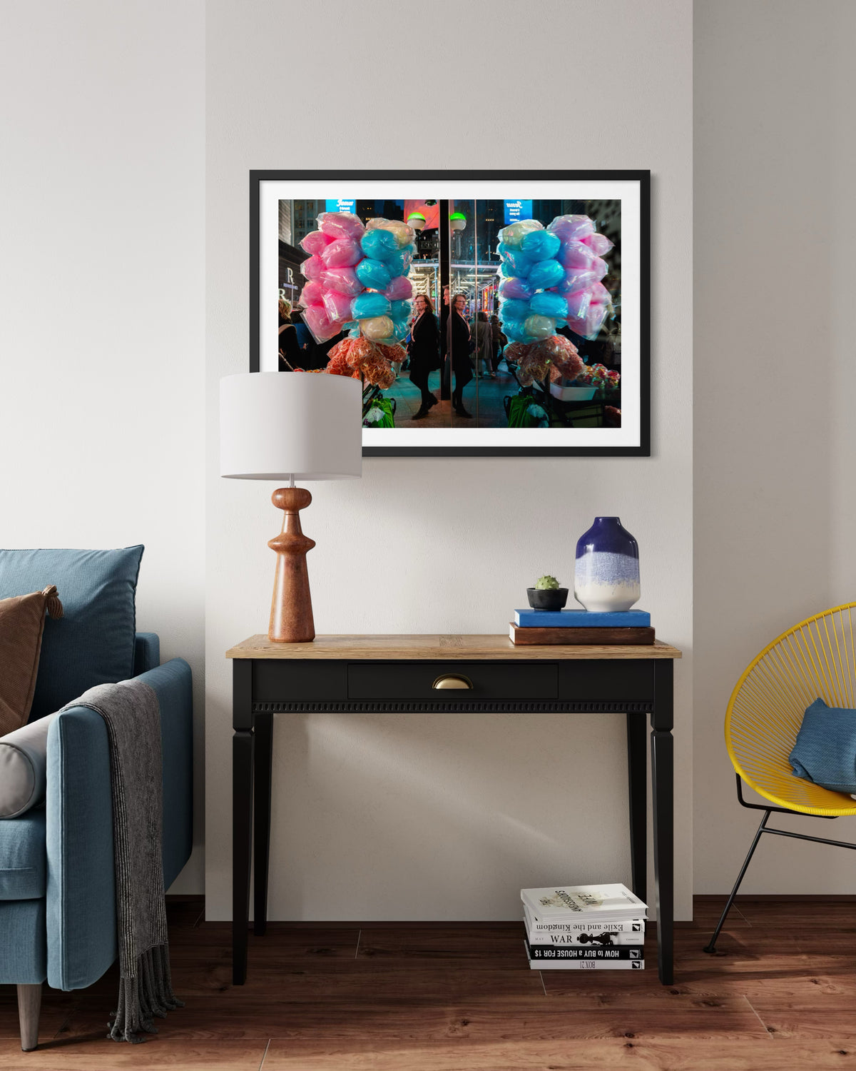 Framed “Sweet Reflections” print depicting playful reflections, displayed above a modern desk and lamp in a living room.