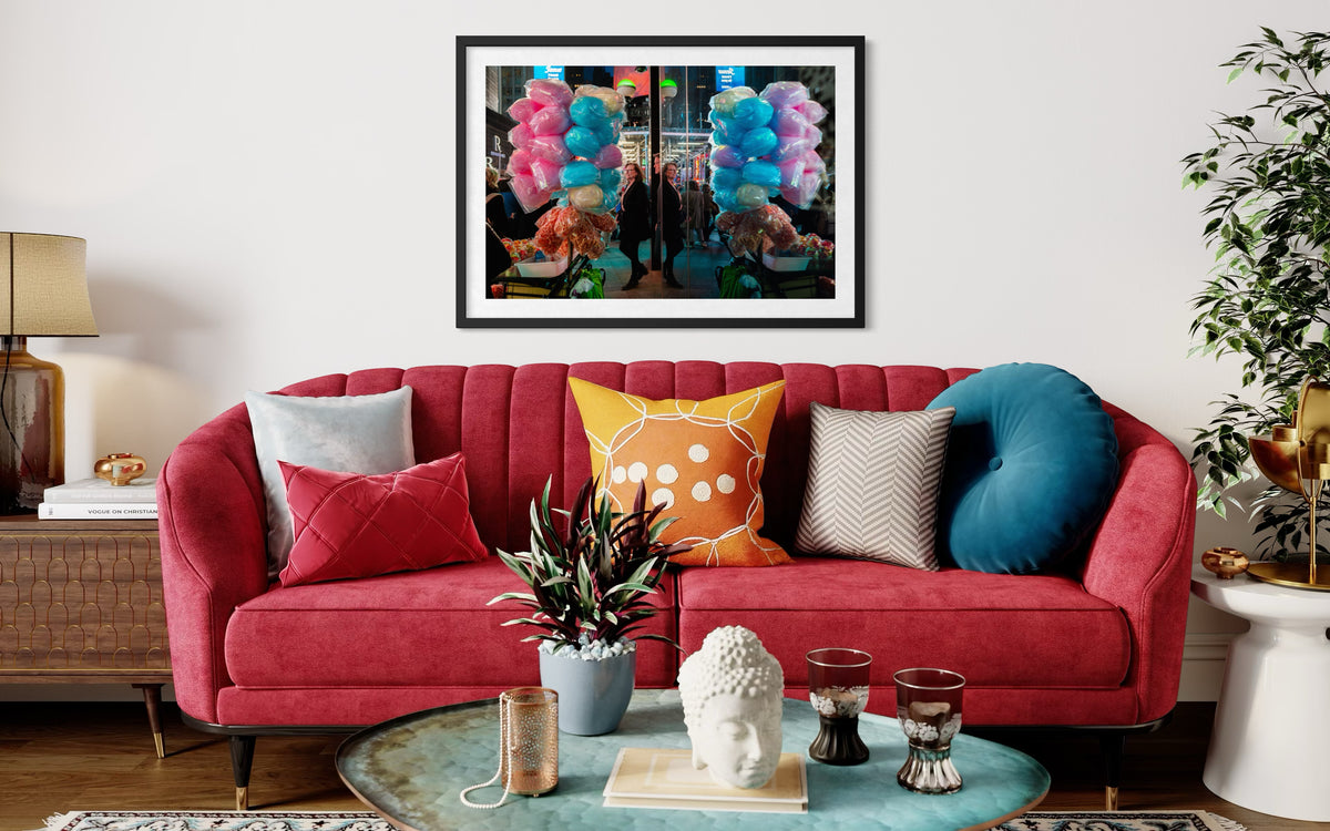 Sweet Reflections framed print displayed above a red sofa with multicolored pillows in a modern living room mockup.