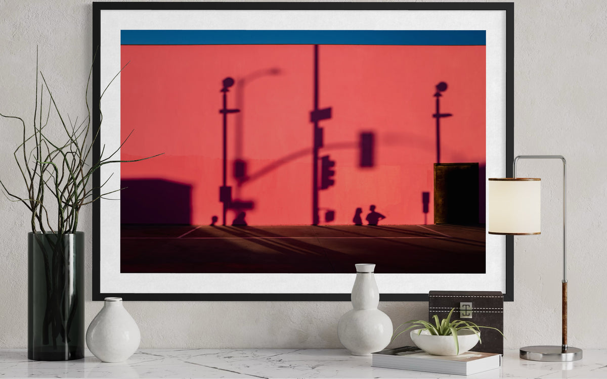 LA street shadows cast on a pink wall above a marble table with vases and a lamp, from That Pink Wall series.