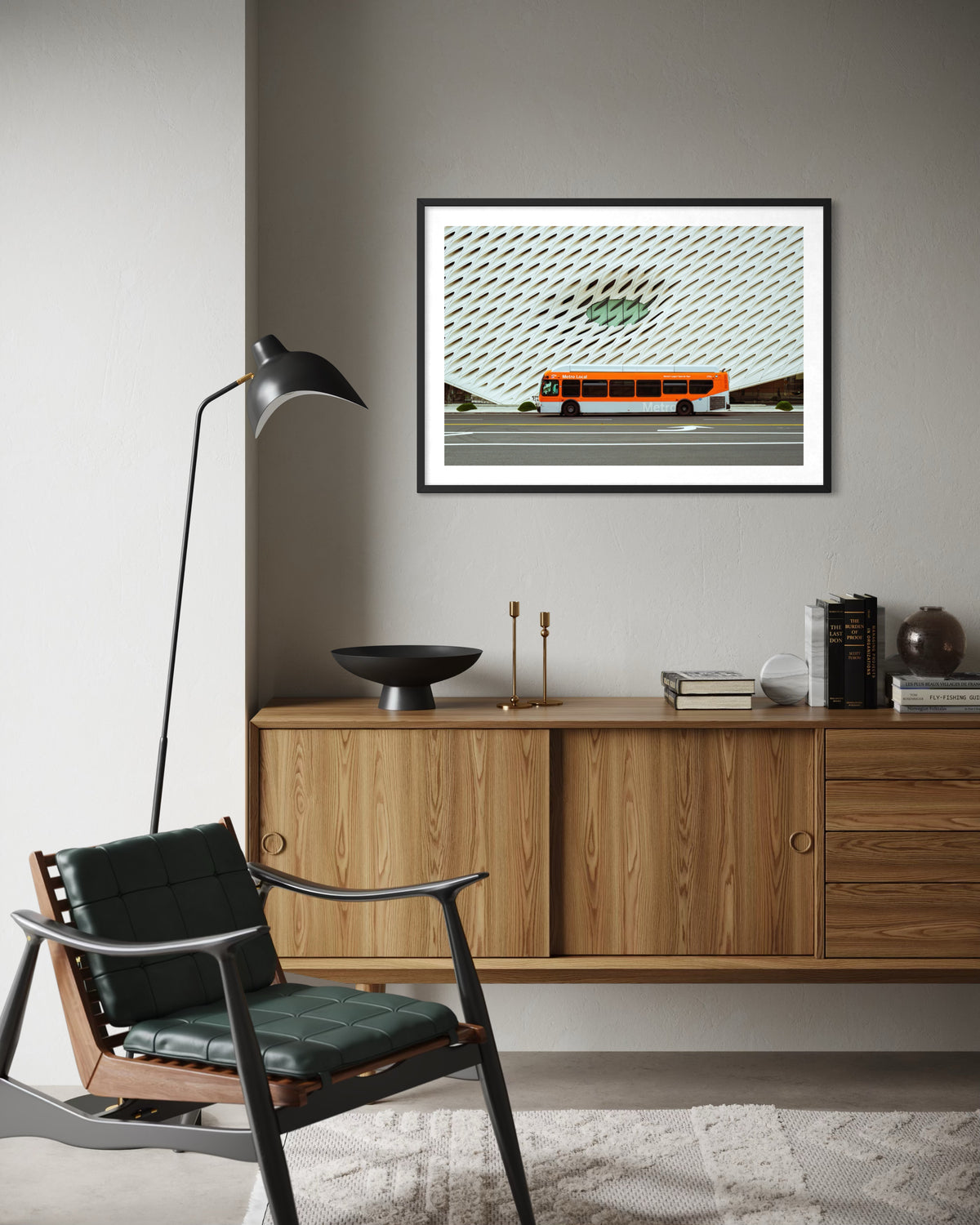 Framed photo of The Broad in Los Angeles on a cabinet, black chair and lamp in modern living room.
