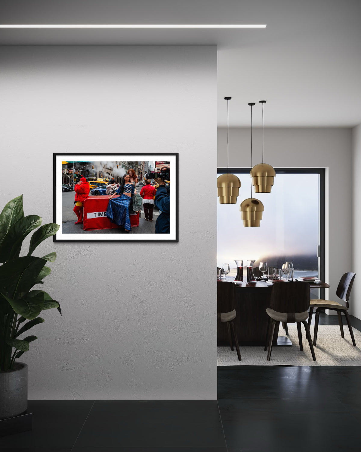 Framed “Times Square Confluence” print displayed on a white wall above a modern dining area with hanging lights.