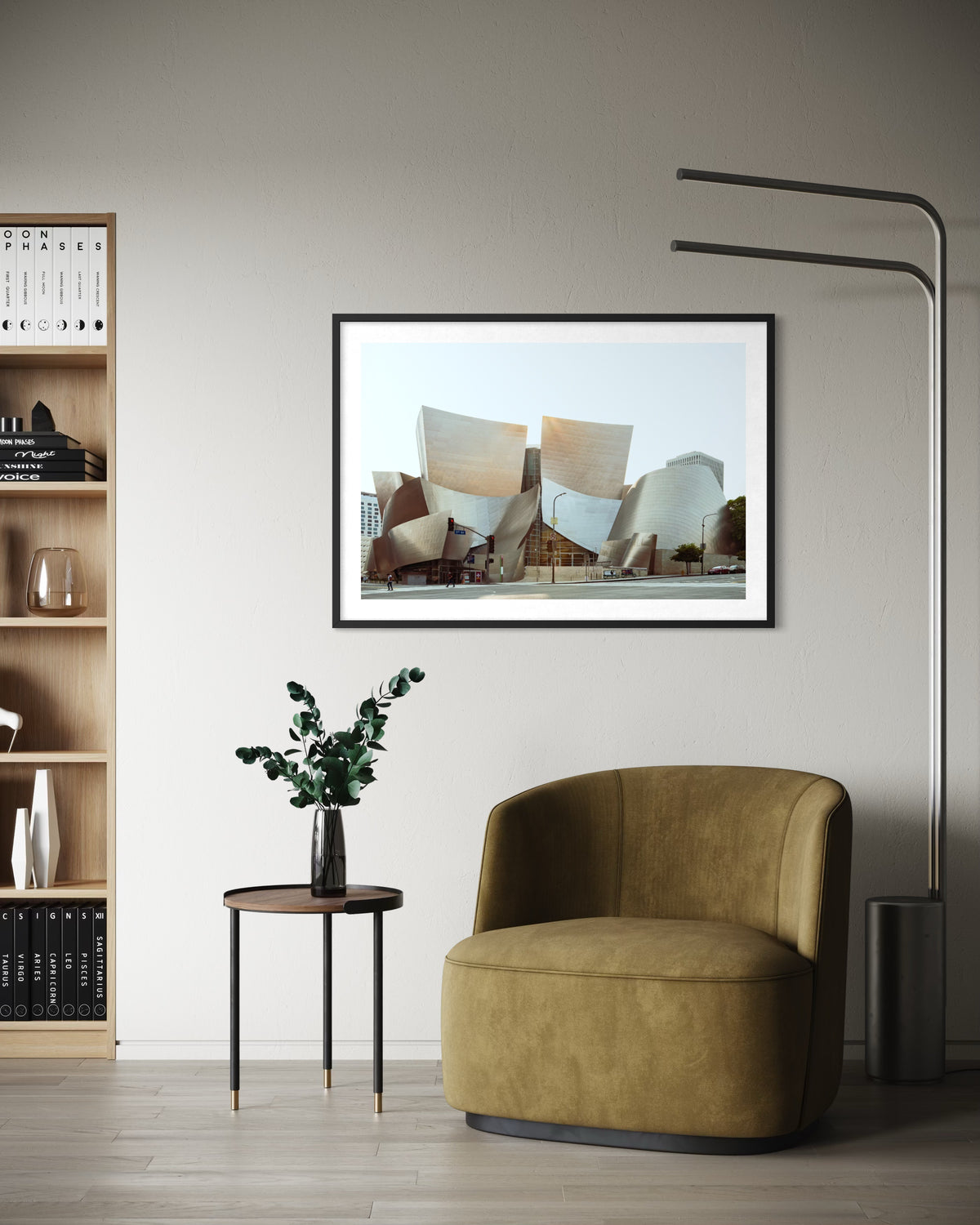 Framed print of Walt Disney Concert Hall, Los Angeles, hangs above a green chair in a modern living room.