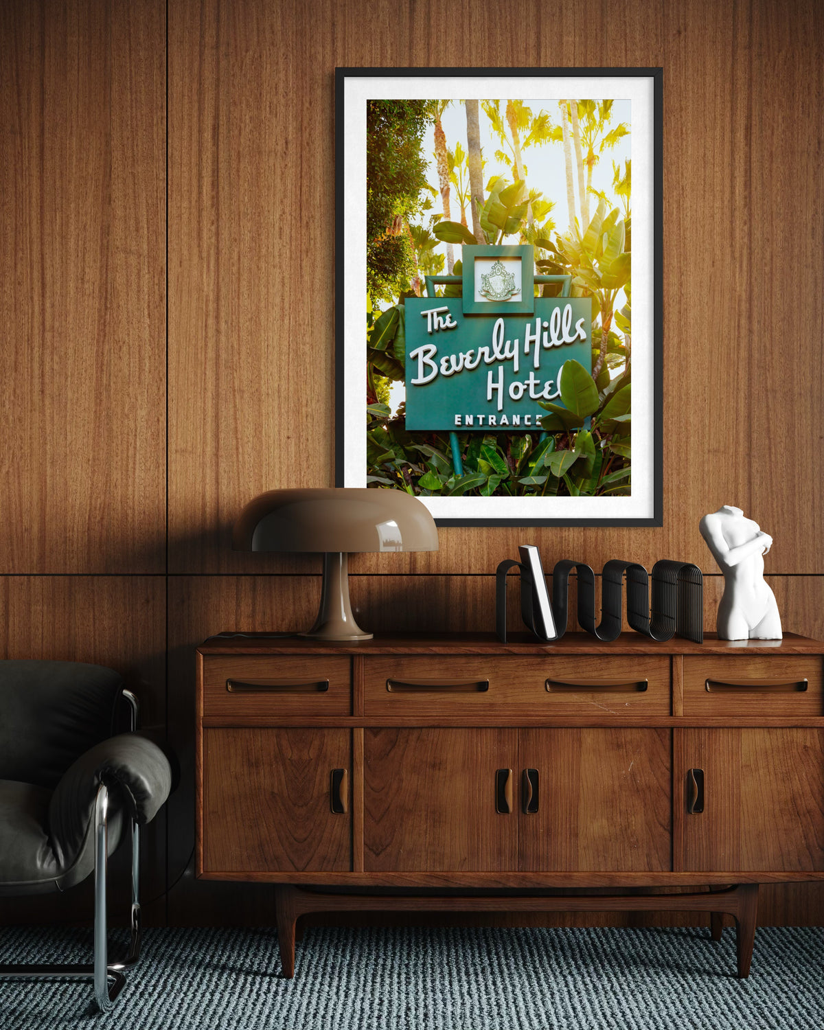 Framed Beverly Hills Hotel sign photo hangs on a wood wall above a vintage sideboard in a room setting.