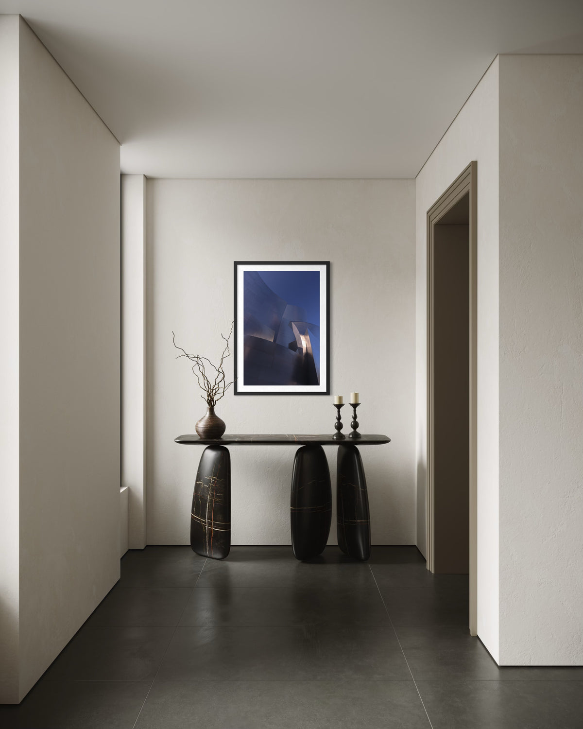 Blue Gehry console table, candles, and art in a minimalist hallway, photographed indoors.