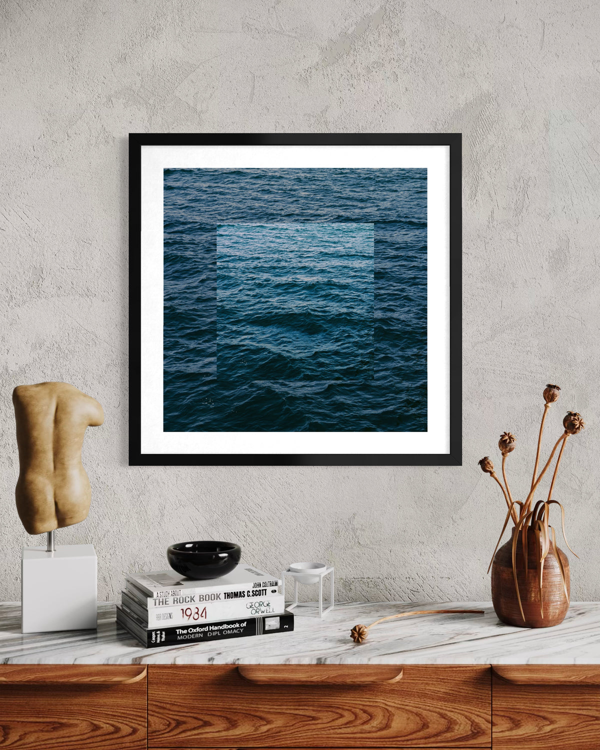 Waves in the Blue Ocean print, framed and hung above a wooden dresser with minimal decor and dried flowers.
