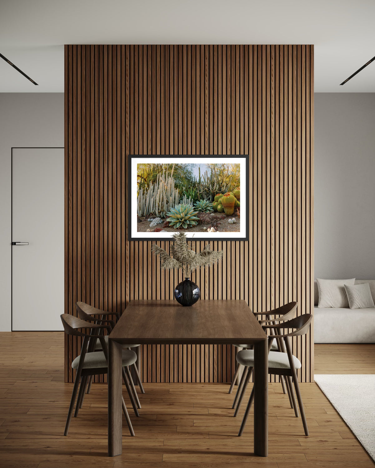 Modern dining room with a wood accent wall, table, four chairs, cactus art, vase, and natural decor elements.