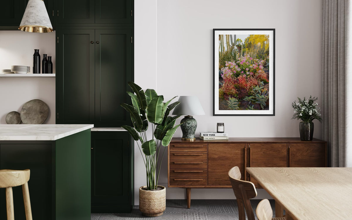 Green cabinets, wood sideboard, and Cactus Garden II artwork in a mid-century modern room.