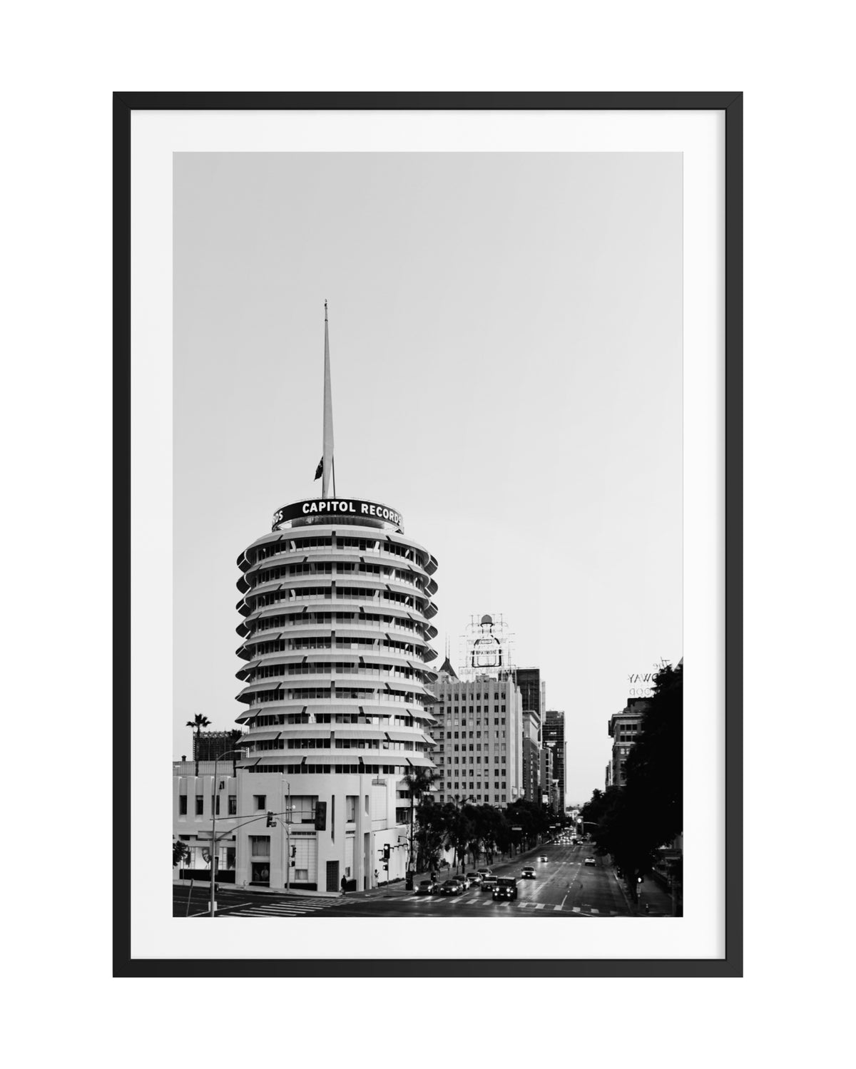 Capitol Records Building in Hollywood, seen in black and white with cars and city streets in the background.