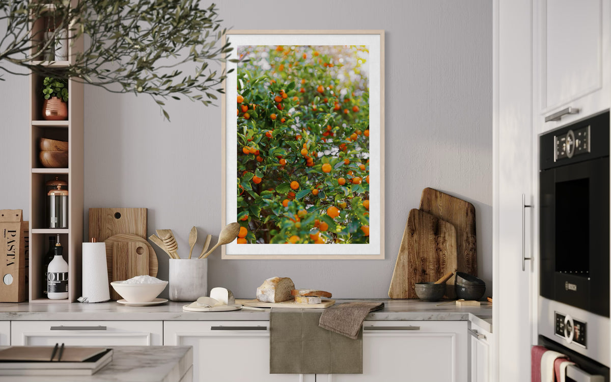Kitchen scene with wooden boards, utensils, and a framed Citrus Summer photo displayed on the wall.