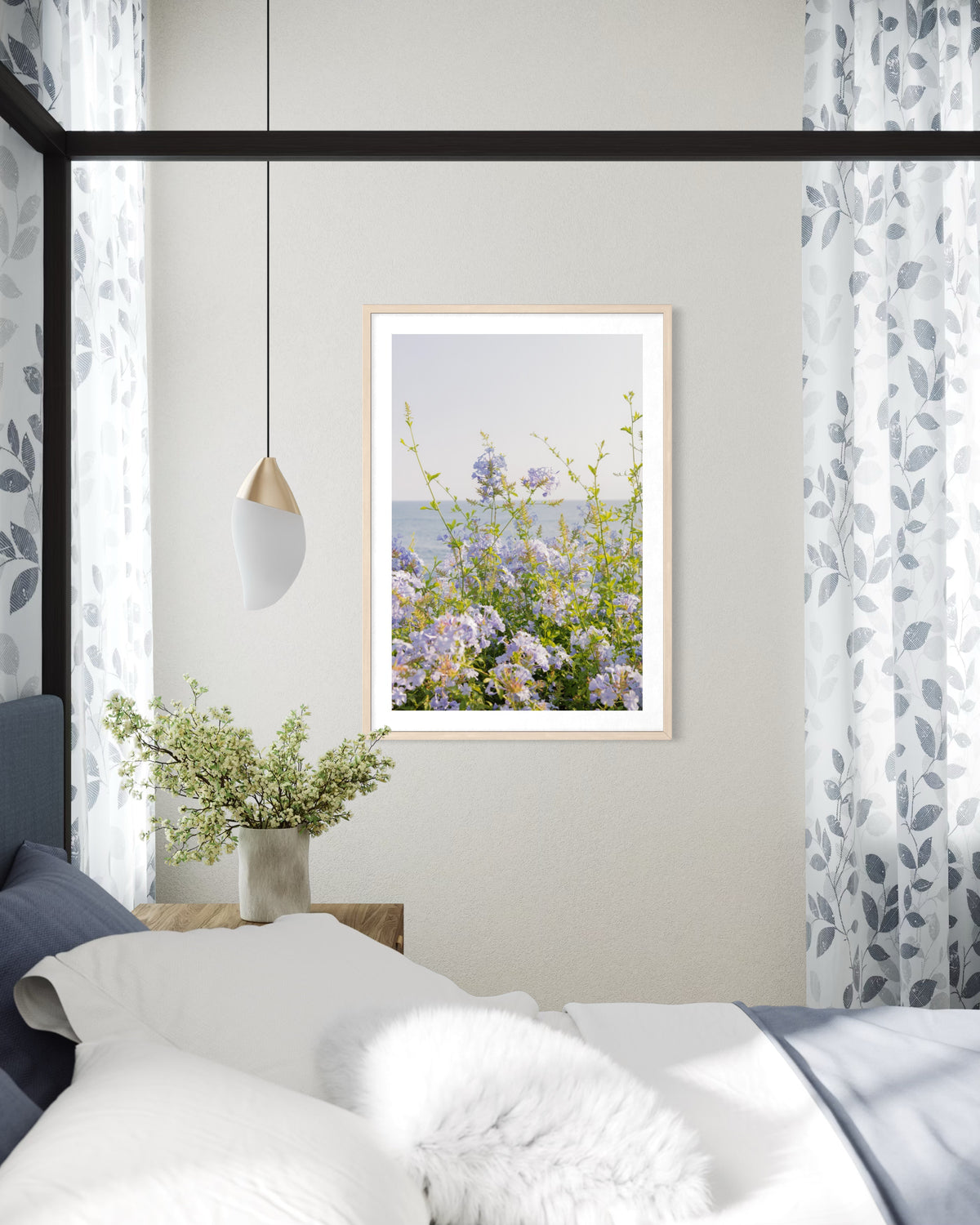 Coastal Flowers print displayed in a bedroom with matching curtains, a vase, and a framed photo on the dresser.